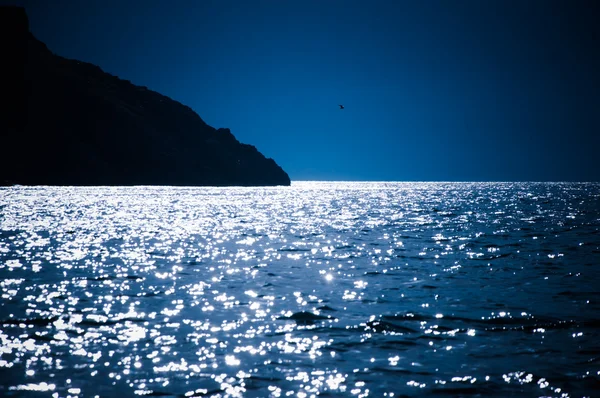 Sparkling sea and dark-blue sky Royalty Free Stock Images