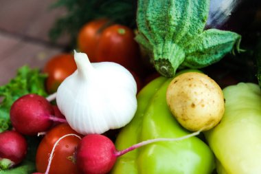An assortment of fresh fruits and vegetables. Environmental products. A farm. Greens, tomatoes, eggplants, onions, garlic, cucumbers from the garden.