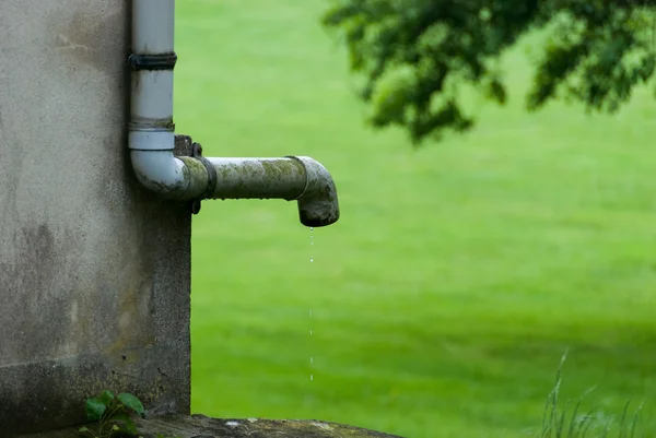 Water leaking from a rain gutter Royalty Free Stock Photos