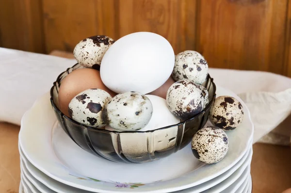 Chicken and quail eggs, healthy food with chicken farm on the table