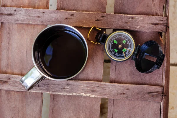 Cup of coffee with compass — Stok fotoğraf