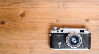 retro camera on wooden background clipart