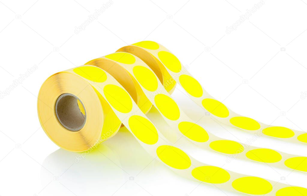 Yellow label rolls isolated on white background with shadow reflection. Reels of colored labels for printer. Labels for direct thermal or thermal transfer printing.