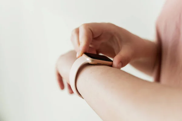 Kaliningrad, Russia - March 9, 2021: Smart clock on hand at a young woman. Close-up of Apple Watch SE series.