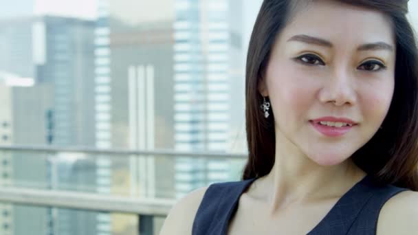 Young Asian businesswoman standing on rooftop — Stock Video