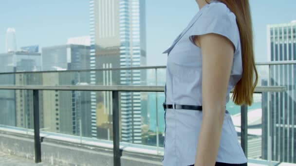 Young Asian businesswoman standing on rooftop — 图库视频影像