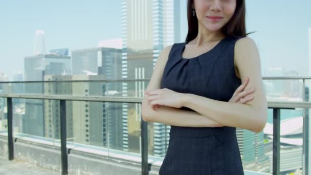 Young Asian businesswoman standing on rooftop — Stock Video