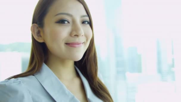 Female Chinese financial consultant smiling to camera — Stock Video