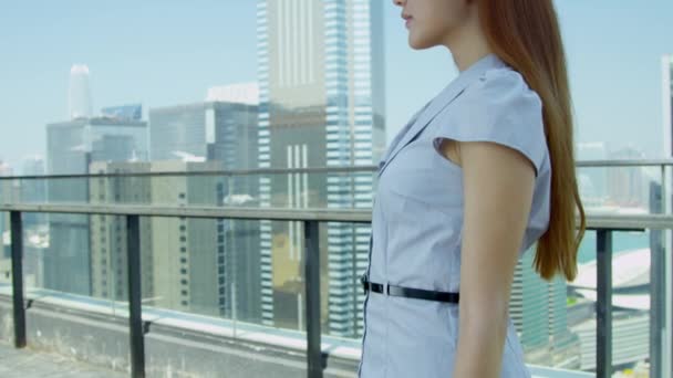 Young Asian businesswoman standing on rooftop — Stock videók