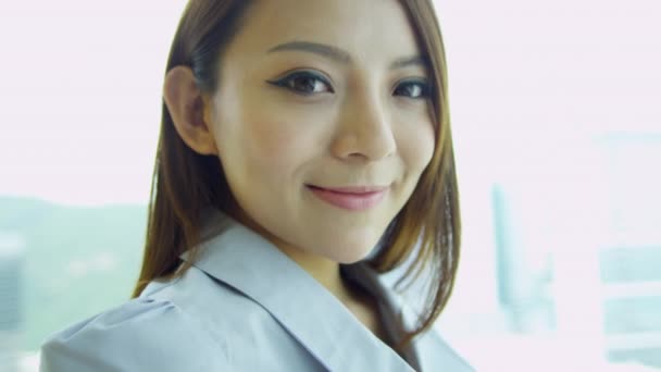 Female Chinese financial consultant smiling to camera — Stock Video