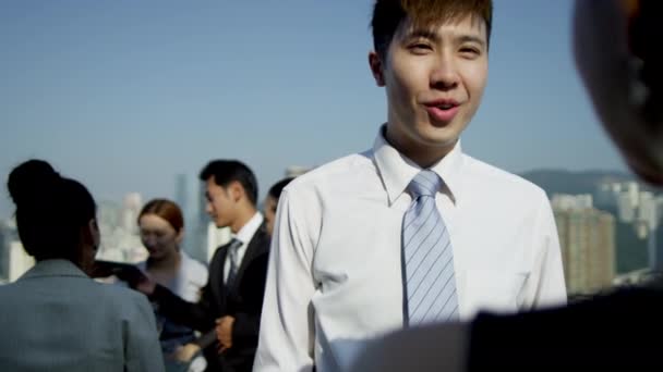 Multi ethnic business people on rooftop — Stock Video