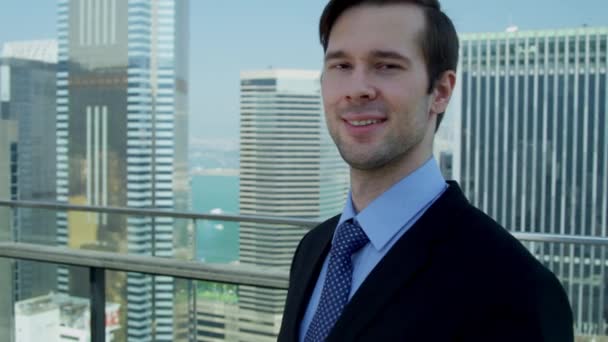 Young caucasian businessman standing on rooftop — Stock Video