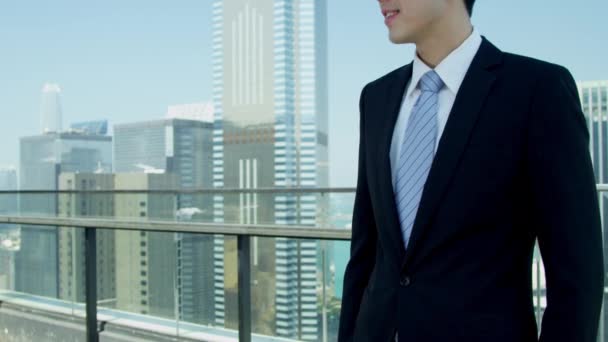 Young Asian businessman standing on rooftop — Stock video