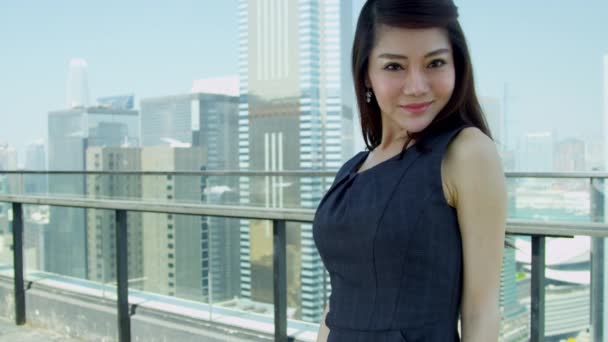 Young Asian businesswoman standing on rooftop — Stock video