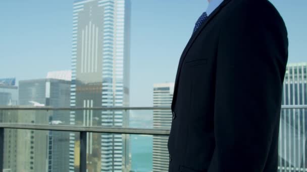 Young caucasian businessman standing on rooftop — Stock Video