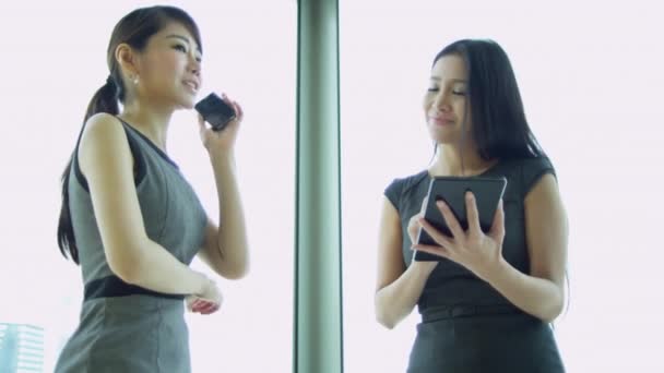 Aziatische zakenvrouwen met smartphone en tablet — Stockvideo