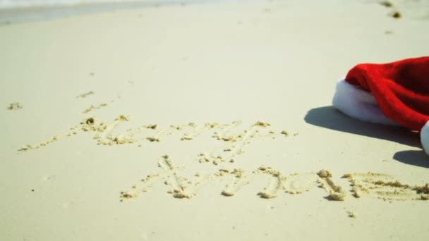 Merry Xmas greeting written in sand — Stock Video