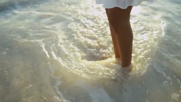 Ung flicka walking av ocean grundområden — Stockvideo