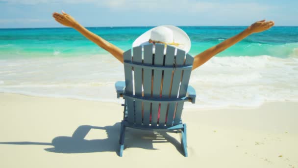 Girl sunbathing on wooden chair on tropical beach — Stock Video