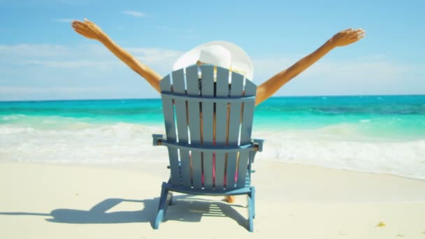 Girl sunbathing on wooden chair on tropical beach — Stock Video