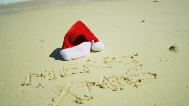 Merry Xmas greeting written in sand — Stock Video