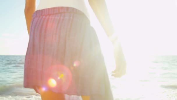 Girl walking barefoot through ocean shallows — Stock Video