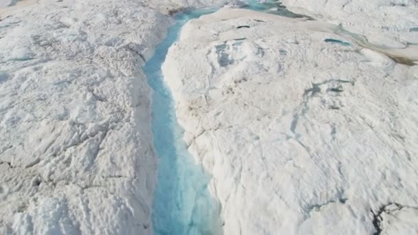 Ice blue water cutting across frozen glacier — Stock Video