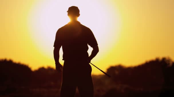 Golf profesional jugando al golf al atardecer — Vídeos de Stock