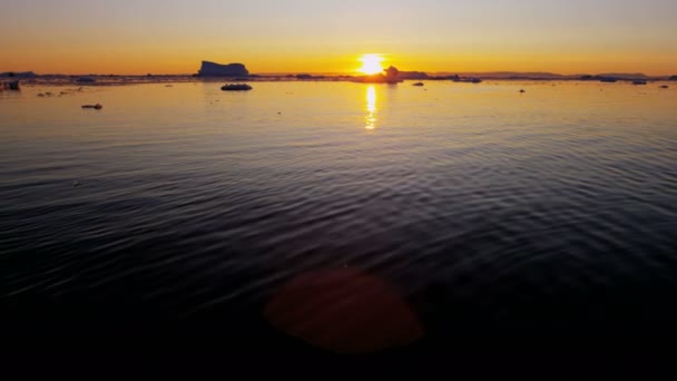 Glacier ice floes floating in water at sunset — Stock Video