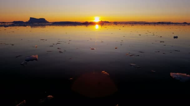 Ledovcové kry plovoucí ve vodě při západu slunce — Stock video