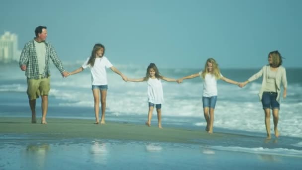 Parents with daughters walking on beach — Stock Video