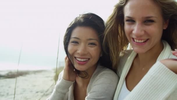 Mujeres sonrientes disfrutando de vacaciones en la playa — Vídeo de stock