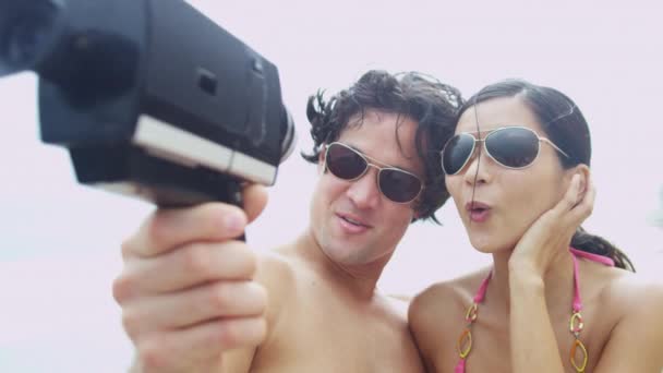 Pár na pláži s videokamerou — Stock video