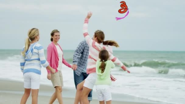 Family having fun with kite on the beach — Stock Video