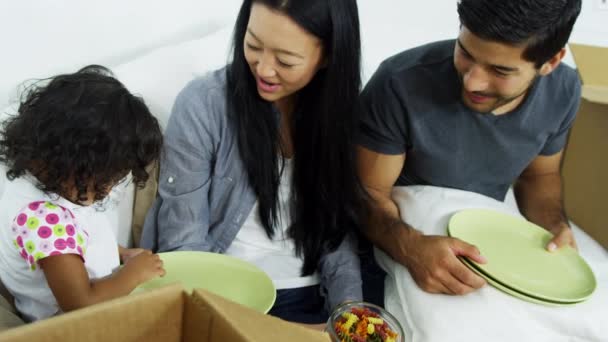 Couple on sofa playing with daughter — Stock Video