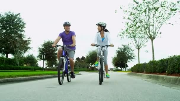 Pareja montando sus bicicletas al aire libre — Vídeos de Stock