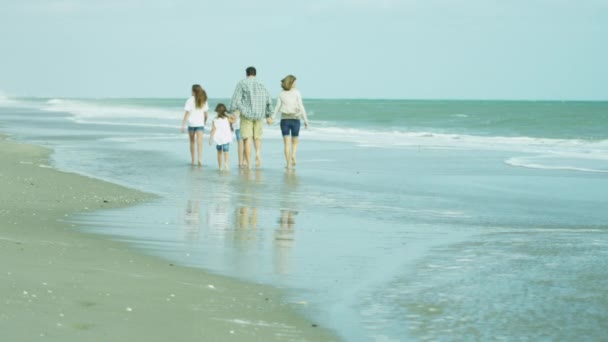 Parents with daughters walking on beach — Stock Video