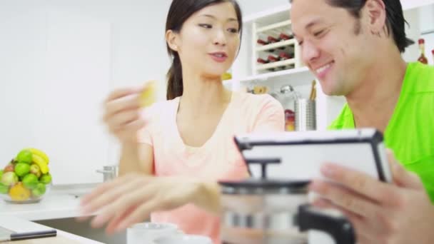 Couple with wireless tablet at kitchen — Stock Video