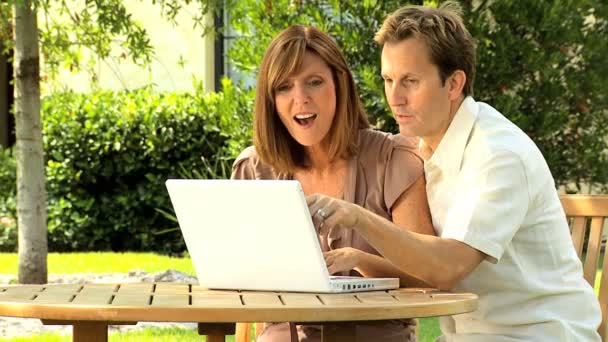 Couple at home garden with laptop computer — Stock Video