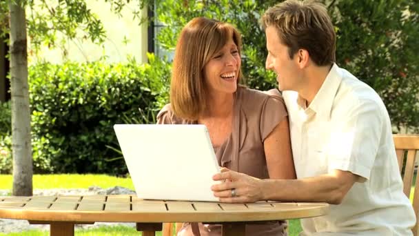 Couple at home garden with laptop computer — Stock Video