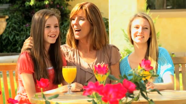 Mother with teenage daughters at home garden — Stock Video