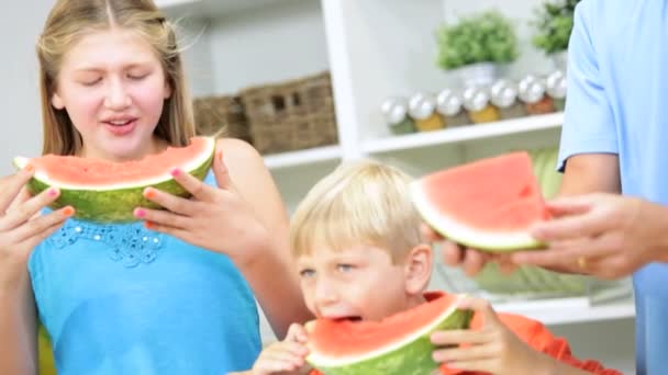 Kinderen met de vader delen van watermeloen — Stockvideo