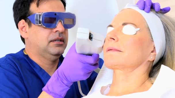 Cosmetic surgeon performing facial treatment — Stock Video