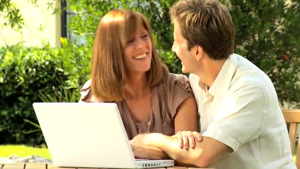 Couple at home garden with laptop computer — Stock Video