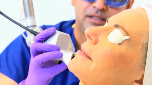 Cosmetic surgeon performing facial treatment — Stock Video