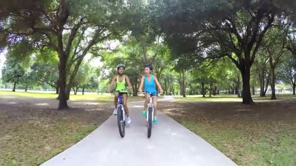 Multi mulheres étnicas andar de bicicleta no parque — Vídeo de Stock