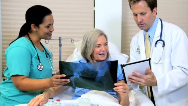 Patient looking x-ray images with radiologist staff — Stock Video