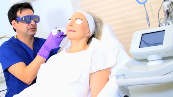 Cosmetic surgeon performing facial treatment — Stock Video