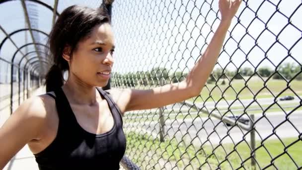 Woman runner resting on bridge during training — Stock Video