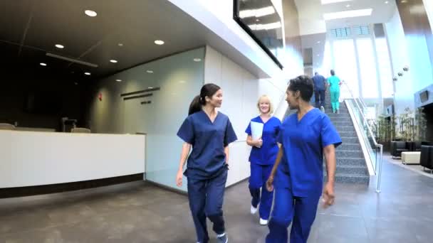 Multi ethnic nurses in hospital entrance — Stock Video